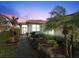 Well-maintained home exterior, featuring a walkway and lush landscaping at 6730 Greenview Ln, Englewood, FL 34224