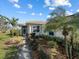 Inviting walkway to the house entrance, surrounded by greenery at 6730 Greenview Ln, Englewood, FL 34224