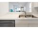 Kitchen with double sink and views to living room at 6730 Greenview Ln, Englewood, FL 34224