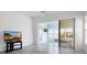 Living room with sliding glass doors leading to a sunroom at 6730 Greenview Ln, Englewood, FL 34224