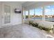 Relaxing sunroom with water views and a large TV at 6730 Greenview Ln, Englewood, FL 34224