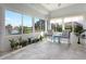 Bright sunroom with water views, comfy seating, and plenty of plants at 6730 Greenview Ln, Englewood, FL 34224