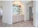 Built-in wet bar with glass shelving and cabinetry at 6730 Greenview Ln, Englewood, FL 34224