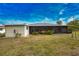 Backyard view showcasing home and shed at 7411 Ebro Rd, Englewood, FL 34224