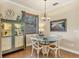 Dining room with a circular glass table with seating for four and a cabinet for storage and display at 8389 Hebron Rd, Port Charlotte, FL 33981