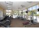 Well-equipped gym featuring state-of-the-art fitness equipment and large windows for natural light at 8411 Placida Rd # 206, Placida, FL 33946