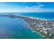 Aerial view of coastline with beach, homes, and boat docks at 8888 Bay St, Placida, FL 33946