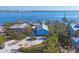 Aerial view of waterfront home with boat docks and surrounding houses at 8888 Bay St, Placida, FL 33946
