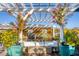 Relaxing hot tub with pergola and lush landscaping at 8888 Bay St, Placida, FL 33946