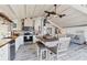 Open concept kitchen features white cabinets, a wood table, and a view into the living room at 8888 Bay St, Placida, FL 33946