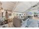 Living room with vaulted ceilings, fireplace, and access to deck at 8888 Bay St, Placida, FL 33946