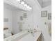 Double sink vanity with large mirror and bright lighting at 9238 Melody Cir, Port Charlotte, FL 33981