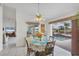 Bright dining area with pool view, seating for four at 9238 Melody Cir, Port Charlotte, FL 33981