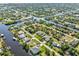 Aerial view of a waterfront community with houses and canals in a tropical setting at 9533 Arnaz Cir, Port Charlotte, FL 33981