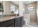 Bathroom featuring granite countertops, a walk-in shower with tile surround, and wood-look tile floors at 9533 Arnaz Cir, Port Charlotte, FL 33981