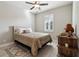 Cozy bedroom with a ceiling fan, white shutters on the windows, and wood-look floors at 9533 Arnaz Cir, Port Charlotte, FL 33981
