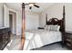 Bedroom features a four-poster bed, ceiling fan, neutral walls, wood floors, and a closet at 9533 Arnaz Cir, Port Charlotte, FL 33981