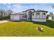 Beautiful single-story home with a well-maintained lawn and manicured landscaping at 9533 Arnaz Cir, Port Charlotte, FL 33981