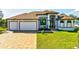 Charming single-Gathering home with a three-car garage and well-manicured lawn at 9533 Arnaz Cir, Port Charlotte, FL 33981