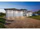 Beautiful home at dusk with a three-car garage and brick-paved driveway at 9533 Arnaz Cir, Port Charlotte, FL 33981