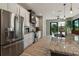 Bright kitchen shows stainless appliances, granite countertops, and backyard access at 9533 Arnaz Cir, Port Charlotte, FL 33981