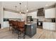 Well-lit kitchen features a gray island, stainless steel appliances, and granite countertops at 9533 Arnaz Cir, Port Charlotte, FL 33981