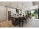 Bright kitchen boasts a gray island with bar seating and stainless steel appliances at 9533 Arnaz Cir, Port Charlotte, FL 33981