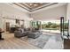 Open-concept living space with modern furnishings, seamless flow to outdoor pool area at 9533 Arnaz Cir, Port Charlotte, FL 33981