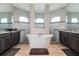 Luxurious main bathroom featuring a freestanding tub, granite countertops, and elegant finishes at 9533 Arnaz Cir, Port Charlotte, FL 33981