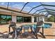 Relaxing pool area with lounge chairs and a beautiful view through the screen enclosure at 9533 Arnaz Cir, Port Charlotte, FL 33981