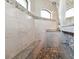 Spa-like walk-in shower with marble-like tiling, a built-in bench, and decorative accents at 9533 Arnaz Cir, Port Charlotte, FL 33981