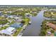 Beautiful aerial shot of the property with canal access, a screened pool, and lush greenery surrounding the area at 9548 Applin Cir, Port Charlotte, FL 33981