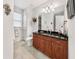 Elegant bathroom with a dark granite countertop, ample cabinet space, and modern fixtures for a luxurious feel at 9548 Applin Cir, Port Charlotte, FL 33981