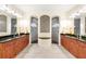 This bathroom offers dual sinks, ample counter space, and stunning, tiled walk-in showers at 9548 Applin Cir, Port Charlotte, FL 33981