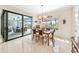 Bright dining room featuring large windows and sliding glass doors to the screened-in lanai at 9548 Applin Cir, Port Charlotte, FL 33981