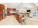 Gourmet kitchen boasts granite counters, stainless appliances, island with seating, and easy access to the open-concept living area at 9548 Applin Cir, Port Charlotte, FL 33981