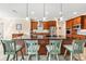 Kitchen with a large island with seating, wooden cabinets, and modern stainless-steel appliances creates an inviting space at 9548 Applin Cir, Port Charlotte, FL 33981