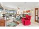 Spacious living room with pool view offers comfortable seating, sleek tile floors, and an open layout, ideal for entertaining at 9548 Applin Cir, Port Charlotte, FL 33981