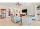 Bright living room with tile flooring featuring comfortable seating and a view into the entryway and other living spaces at 9548 Applin Cir, Port Charlotte, FL 33981