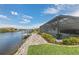 Waterfront home featuring a screened-in pool, private dock and paver walkway along the canal at 9548 Applin Cir, Port Charlotte, FL 33981