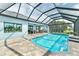 Lush screened-in pool area with ample space for lounging and a sparkling pool, perfect for relaxation and recreation at 9548 Applin Cir, Port Charlotte, FL 33981