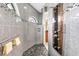 A spacious walk-in shower features beautiful tiling, a rainfall shower head, and lots of custom features at 9548 Applin Cir, Port Charlotte, FL 33981