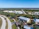 Aerial view of a building, parking lot, and surrounding area at 9900 Fiddlers Green Cir # 137, Rotonda West, FL 33947