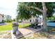 Community BBQ area with picnic tables and gas grill at 9900 Fiddlers Green Cir # 137, Rotonda West, FL 33947