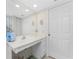 Bathroom with vanity, large mirror, and a door at 9900 Fiddlers Green Cir # 137, Rotonda West, FL 33947