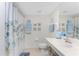 Bathroom with shower, floral curtain, and vanity at 9900 Fiddlers Green Cir # 137, Rotonda West, FL 33947