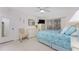 Bedroom with light teal bedding, dresser, and ceiling fan at 9900 Fiddlers Green Cir # 137, Rotonda West, FL 33947