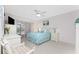 Peaceful bedroom with white furniture and teal bedding at 9900 Fiddlers Green Cir # 137, Rotonda West, FL 33947