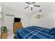 Bedroom with blue bedding, dresser, and ceiling fan at 9900 Fiddlers Green Cir # 137, Rotonda West, FL 33947