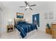 Bedroom with blue and white bedding and wicker furniture at 9900 Fiddlers Green Cir # 137, Rotonda West, FL 33947
